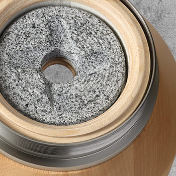 Der stehende Mahlstein im Trichter ebenso aus handbearbeitetem Granit